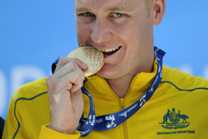 brenton rickard bites gold wr 100m breaststroke photo patrick kraemer.jpg